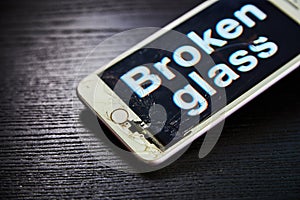 Image of smartphone with broken screen and the word Broken on it