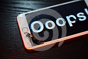 Image of smartphone with broken screen and the word Ooops! on it