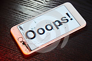 Image of smartphone with broken screen and the word Ooops! on it