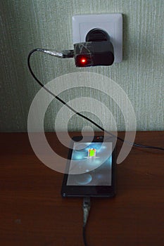 Charging the smartphone from the mains.