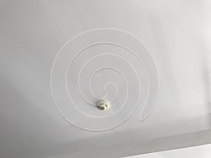 Image of an smoke detector fixed on an Gypsum false ceiling interiors of an location and roof are painted using acrylic Emulsion