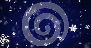 Image of snow flakes falling on blue background