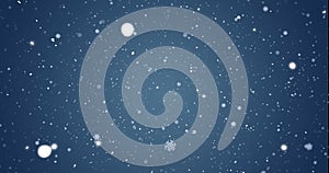 Image of snow flakes falling on blue background