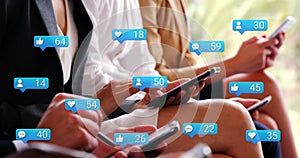 Image of social media icons falling over people using smartphone