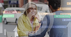 Image of social media icons floating over happy caucasian couple talking and drinking coffee