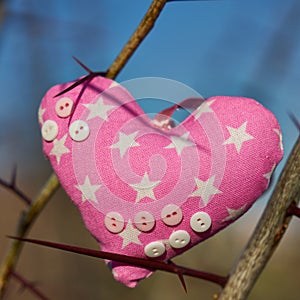 An image of a soft toy in the shape of a heart. Handicraft work