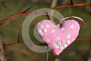 An image of a soft toy in the shape of a heart. Handicraft work