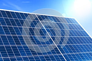 Image of solar panel with sunlight on blue sky background