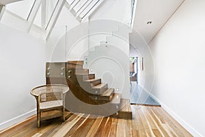 Image of solid wooden stairs with elegant glass balustrade photo
