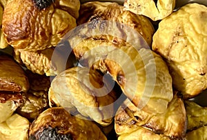 Image of some chestnuts roasted in a pan on the fire of the fireplace, already peeled, a delicious delicacy and a pleasure.