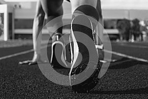 Image of spiked shoes at the start line of the track. Running concept