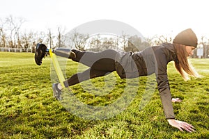 Image of sporty handicapped woman in black tracksuit, warming up