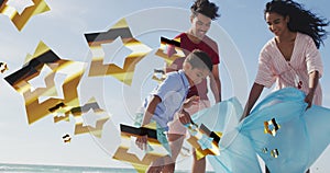 Image of stars over biracial family cleaning beach