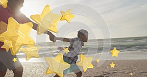 Image of stars over biracial man with grandson at beach