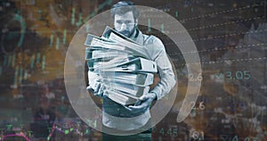 Image of statistics and financial data processing over caucasian man holding files