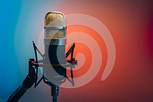 Image Studio podcast microphone on gradient blue background, broadcasting equipment photo