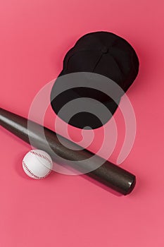 Image of Stylish Laquered Wooden Brown American Baseball Bat Placed With Clean Leather White Baseball Ball and Black Cap Over