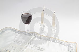 Image subject of Sabbath, a day sacred to the Jewish people. Hand pouring wine cup of sanctification, and Shabbat candles are