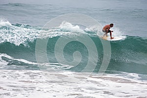 Surfer on Blue Ocean Wave, Bali, Indonesia. Riding in tube.