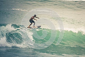 Surfer on Blue Ocean Wave, Bali, Indonesia. Riding in tube.