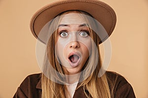 Image of surprised girl wearing hat expressing wonder with open mouth