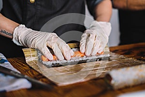 Image of a sushi master preparing a california roll