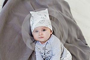 Image of sweet baby girl in a cute hat, closeup portrait of cute 6 month old smiling girl, toddler.