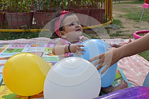 Image of sweet baby girl in a wreath, closeup portrait of cute 12 months old smiling girl, toddler, Adorable little baby girl,