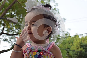 Image of sweet baby girl in a wreath, closeup portrait of cute 12 months old smiling girl, toddler, Adorable little baby girl,