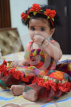 Image of sweet baby girl in a wreath, closeup portrait of cute 12 months old smiling girl, toddler, Adorable little baby girl,