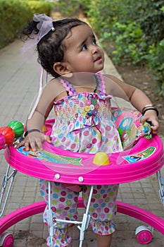 Image of sweet baby girl in a wreath, closeup portrait of cute 12 months old smiling girl, toddler, Adorable little baby girl, smi