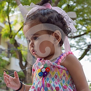 Image of sweet baby girl in a wreath, closeup portrait of cute 12 months old smiling girl, toddler, Adorable little baby girl, smi