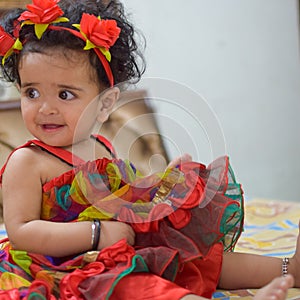 Image of sweet baby girl in a wreath, closeup portrait of cute 12 months old smiling girl, toddler, Adorable little baby girl, smi