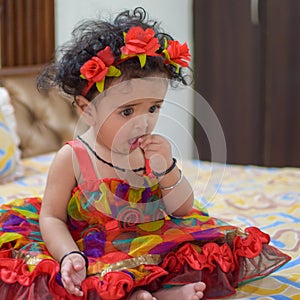 Image of sweet baby girl in a wreath, closeup portrait of cute 12 months old smiling girl, toddler, Adorable little baby girl, smi
