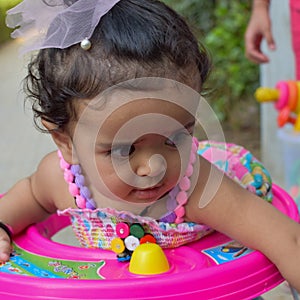 Image of sweet baby girl in a wreath, closeup portrait of cute 12 months old smiling girl, toddler, Adorable little baby girl, smi