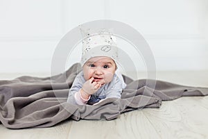 Image of sweet baby girl in a wreath, closeup portrait of cute 6 month old smiling girl, toddler. Cute hat on a head