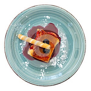 Image of sweet dessert cheese cake served with colorful blueberry topping. Traditional Spanish dish tarta de queso con