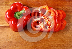 Image of sweet red pepper sliced on hardboard photo