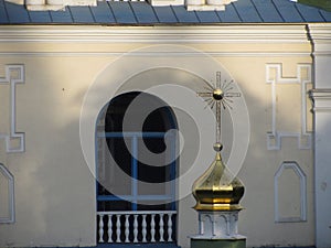 Image of a symmetrical, yellowish architectural structure with a golden star at the center and intricate wrought iron photo