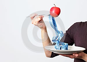 Tasty red apple and tape measure representing slimming and weight loss