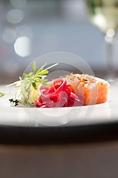 Image of tasty salmon on dish with white vine