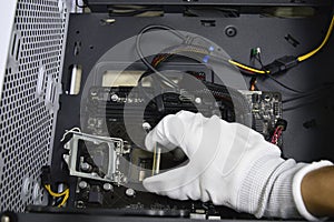 Image of a technician inserting a CPU chip onto a computer motherboard