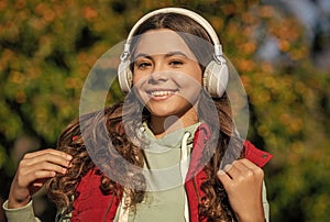 image of teen girl listening music. teen girl listening music outdoor. teen girl listening music