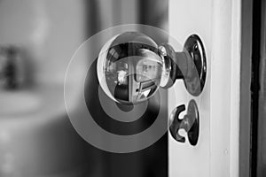 Image though glass doorknob in black and white