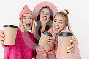 Image of three positive girls smiling and holding takeway coffee cup