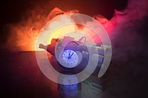Image of a time bomb against dark background. Timer counting down to detonation illuminated in a shaft light shining through the