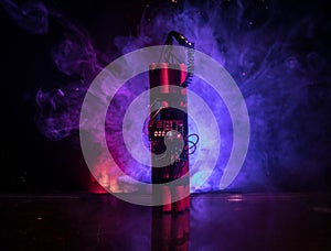 Image of a time bomb against dark background. Timer counting down to detonation illuminated in a shaft light shining through the