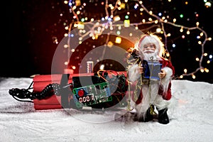 Image of a time bomb against dark background. Timer counting down to detonation illuminated in a shaft light shining through the