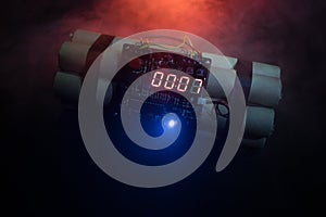 Image of a time bomb against dark background. Timer counting down to detonation illuminated in a shaft light shining through the d