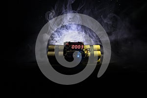 Image of a time bomb against dark background. Timer counting down to detonation illuminated in a shaft light shining through the d